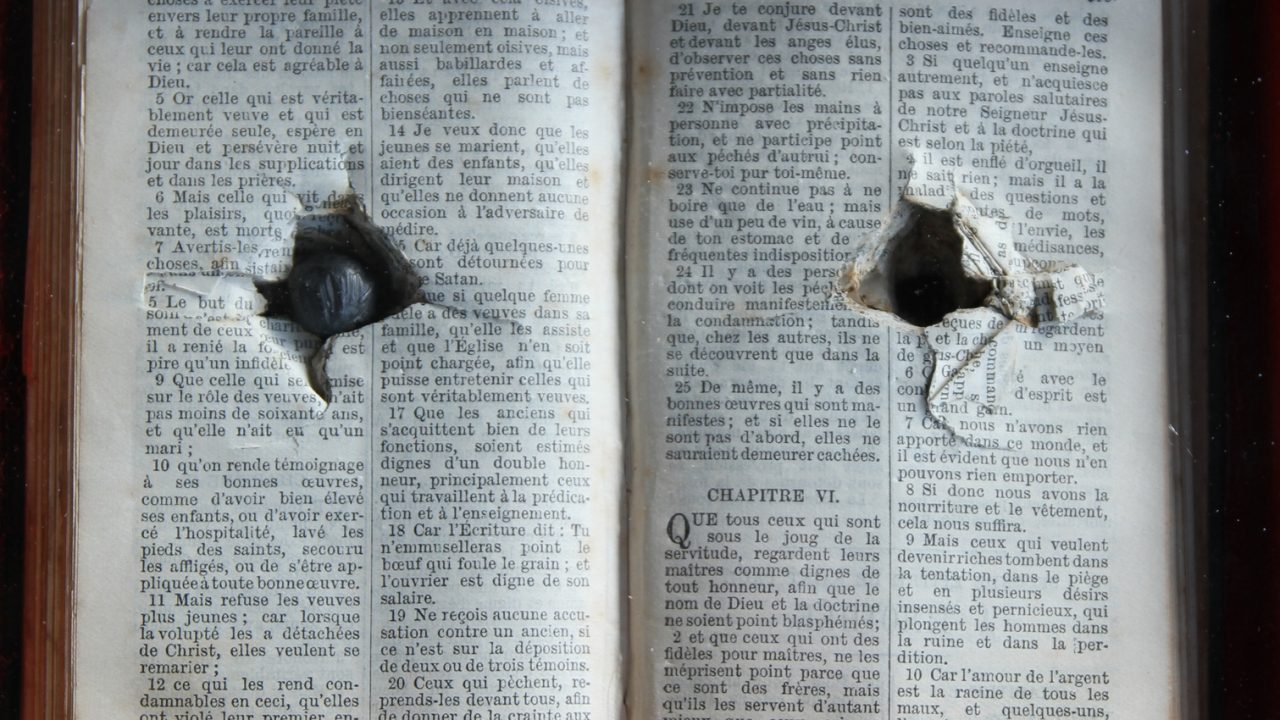 bullet in a bible poster